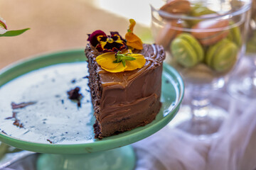 chocolate cake with flowers and macaroni in the display at the flea market