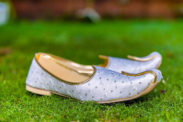 Fototapeta premium Indian groom's wedding shoes close up