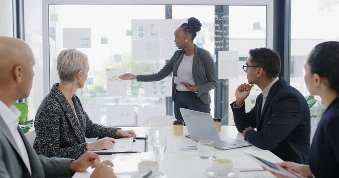 Business woman, manager presentation and meeting statistics, data analytics or financial report on a glass board. Presenter talking of graphs, charts and proposal paper with people listening to ideas