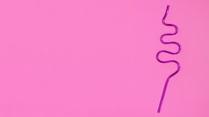 Colorful plastic cocktail straw on a pink background. Flat lay. Copy space