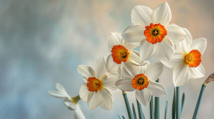 Fototapeta premium a vase filled with white and orange flowers on top of a blue and white table cloth with a bird sitting on top of one of the flowers in front of the vase.