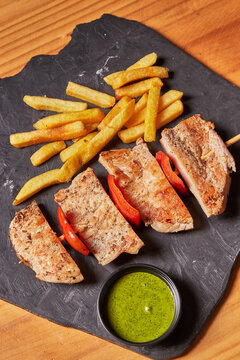 pieces of roast pork with potatoes in chuzo