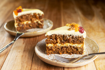 Slices of carrot cake with cream cheese frosting on a plate
