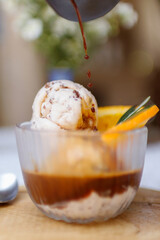 Affogato coffee: espresso shot with chocolate chip icecream on wooden table background.