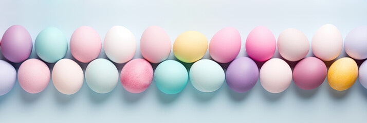 Top view of colorful Easter eggs in two rows on soft blue background. Multicolor painted eggs banner on light surface. Generative AI.