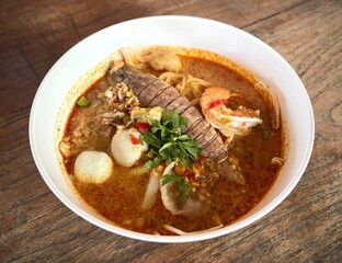 Top view table spicy mixed seafood noodle. (tom yum crayfish, shrimp, fishball)