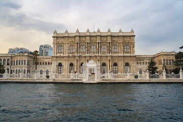 Fototapeta na wymiar Dolmabahce Palace seen from bosporus tour boats and cruise in Istanbul, Turkey