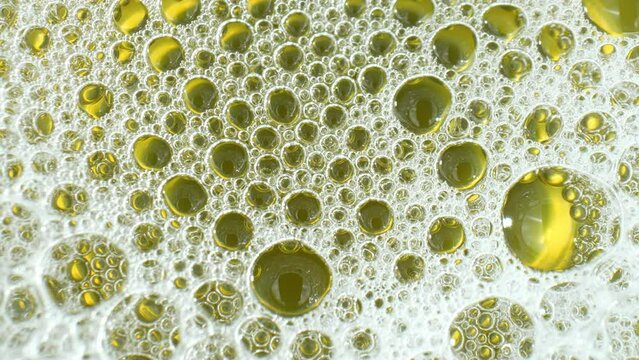 A macro video, foamy urine is observed due to protein molecules aggregating at the surface tension of the liquid. This phenomenon may signify renal issues. Body fluid concept. Stock footage. 4K HDR.
