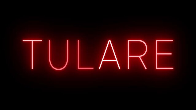 Flickering red retro style neon sign glowing against a black background for TULARE