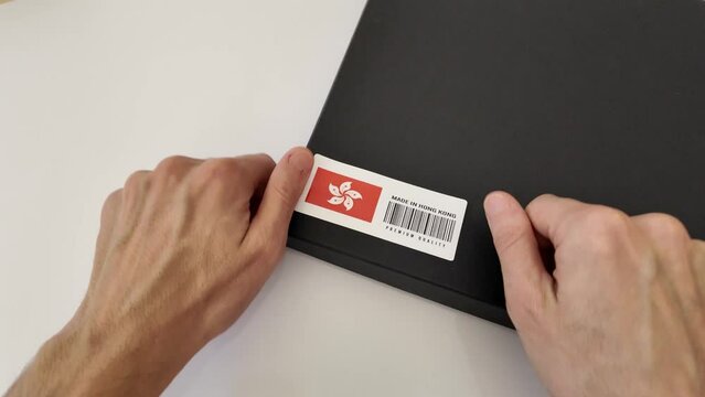 Labeling cargo package with the description Made in Hong Kong, Premium Quality, showing the flag of Hong Kong. Blackbox and white background.