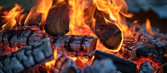 Tuinposter Firewood burning in hearth. Pyre flames. Fire texture in furnace. Combustion. © 2rogan