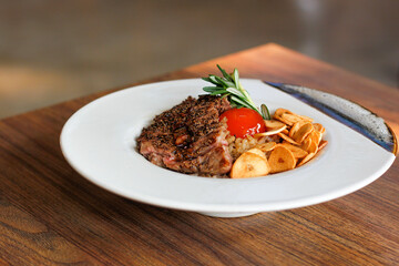 Beef Fried Rice Topping with Wagyu Beef Crispy fried garlic and pickled egg yolks in a white plate on a wooden table