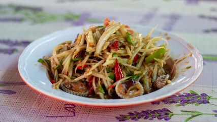 Papaya salad with crab, fermented fish, cockle, Thai food in a Thai dish