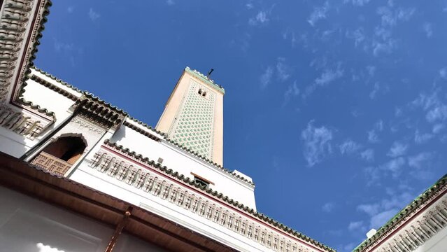 The minaret of Bou inania Madrasa from the perspective of its courtyard. Example of historic Moroccan architecture.