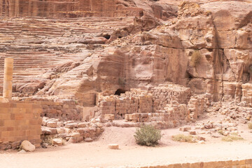 The side part of the well preserved amphitheater carved by Nabatean craftsmen into rock in the Nabatean Kingdom of Petra in the Wadi Musa city in Jordan