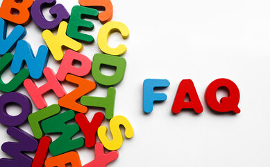 FAQ word made from colourful wooden baby development letters. FAQs Alphabet. Colorful Wooden...