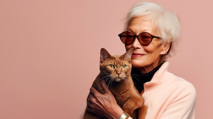 Happy senior lady with cat on beige background.