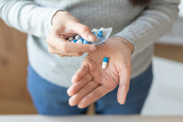 Health care. Sickness, illness asian young woman hand holding, take tablet pill capsule out from...