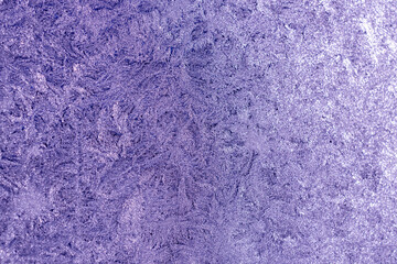 Full frame macro abstract texture background of an ice frosted glass window pane in a color shade of lavender, with copy space
