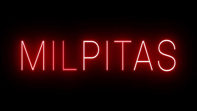 Flickering red retro style neon sign glowing against a black background for MILPITAS