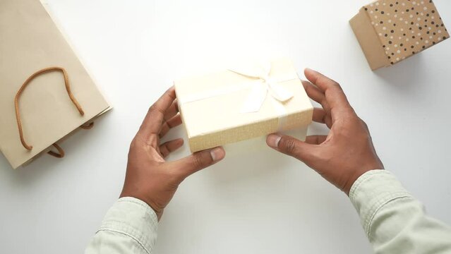 top view of person open a empty small gift box 