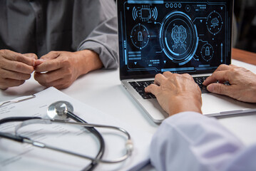 Doctor healthcare worker examines data analysis brain advanced software on a laptop, with a...