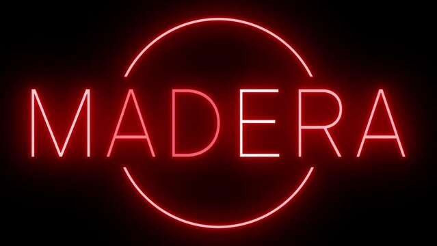 Flickering red retro style neon sign glowing against a black background for MADERA