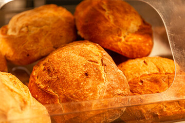 Loaves of fresh bread on the counter in a store. Traditional delicious pastries. Close-up.