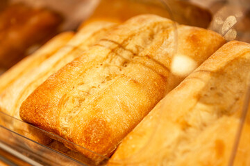 Appetizing fresh baguettes on the counter in a store. Delicious traditional breakfast pastries. Close-up.
