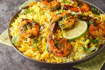 Persian Shrimp Rice Meygoo Polo with herbs and lime closeup on the plate on the table. Horizontal