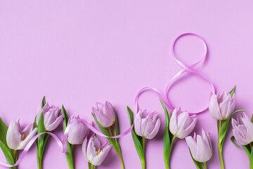 8 March. International Women's Day greeting card. Heap of fresh beautiful lilac tulip flowers on...