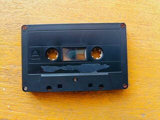  Old cassette tape  On the yellow old wooden background.