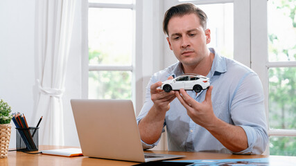 Car design engineer analyze car model prototype for automotive business company at home office....