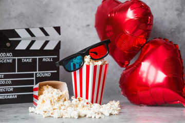 A banner for the film industry. A romantic movie date. A movie camera, 3D glasses, popcorn and foil...
