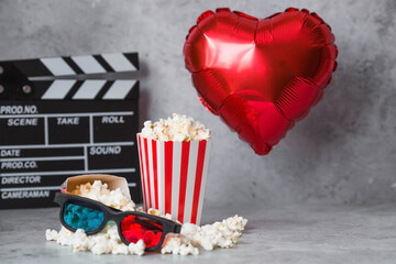 A banner for the film industry. A romantic movie date. A movie camera, 3D glasses, popcorn and foil...