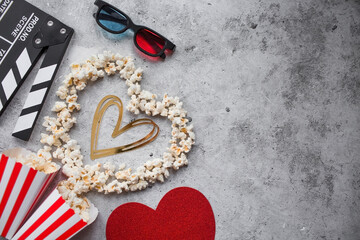 A banner for the film industry. A romantic movie date. A movie camera, 3D glasses, popcorn and a...