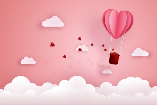 Paper cut art and digital craft style of love and valentine concept. Origami of hot air balloon flying over sky and cloud with floating hearts.