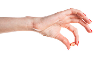 Hand holding a red capsule isolated on white background. Red pill isolated.