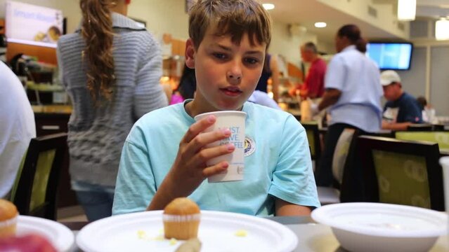 Boy (model with release) drinks coffee in Papa Palheta. 