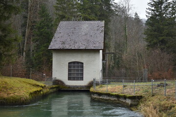 house for drinking water purification equipment on a river in Switzerland