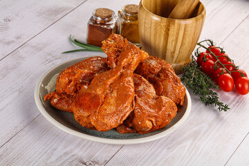 Raw turkey shoulder wing in Indian tandoori marinade