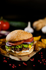 Hamburger with meat patty and cheese. bacon and fresh vegetables