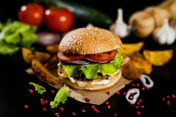 Hamburger with meat patty and cheese. bacon and fresh vegetables