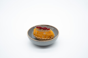 A culinary masterpiece, this delicate tart features a vibrant orange filling crowned with ruby-red berries and an intricate sugar lattice. A true feast for the eyes and the palate.