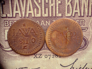 front and back views of ancient Javanese coins.