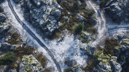  an aerial view of a snow covered mountain with a winding road in the middle of the picture and trees on the other side of the mountain side of the road.