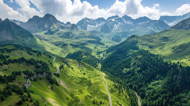  a scenic view of a mountain range with a winding road in the foreground and a winding road in the middle of the mountain range on a sunny day with white clouds in the sky.