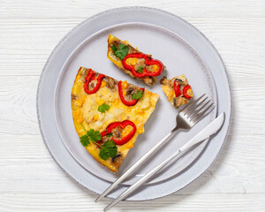 omelette with vegetables in a plate, top view