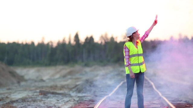 Female worker is drawing circle in the air with a signal light.