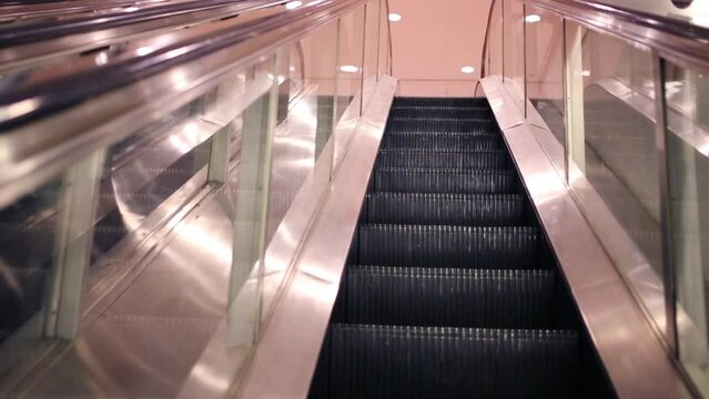 Movement of lifting on modern shiny escalator in building